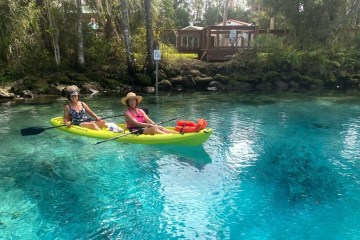 a small girl in a pool of water