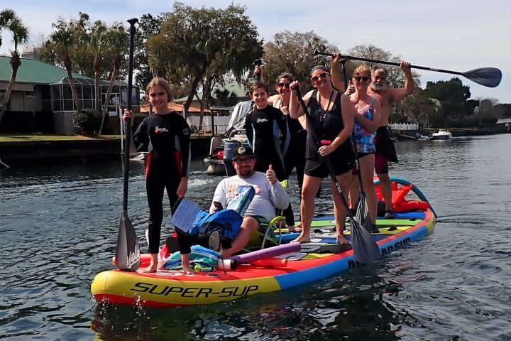 a group of people riding on the back of a boat